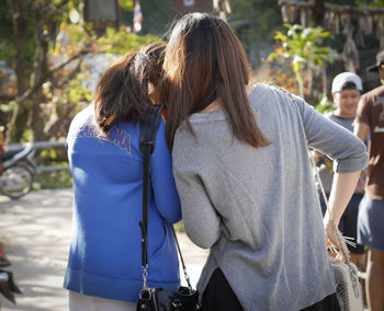 Rear view of women walking outdoors