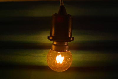 Close-up of lit light bulb