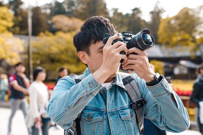 Man photographing on street