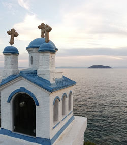 Building by sea against sky