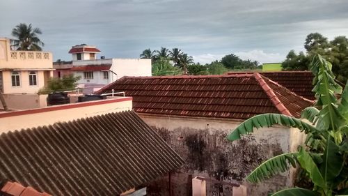 Houses against cloudy sky