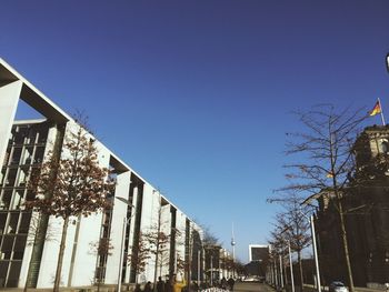 Low angle view of buildings against clear blue sky