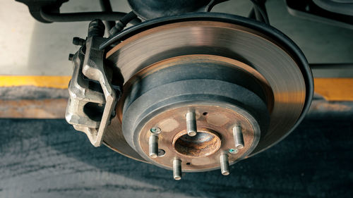 Car disc brake to be fixed at garage or automotive service station, process of tire replacement