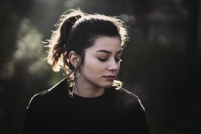 Portrait of a young woman looking away