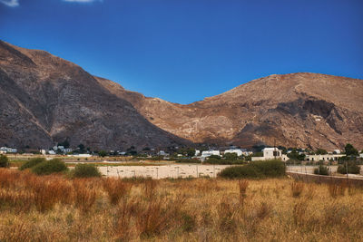 Scenic view of field against clear blue sky