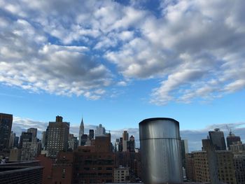 Cityscape against cloudy sky