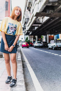 Full length of woman standing on street in city