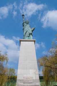 Low angle view of statue against cloudy sky