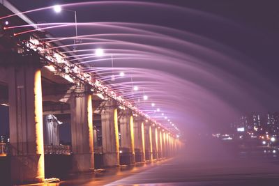 Illuminated lights on bridge at night