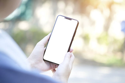 Close-up of hand holding mobile phone