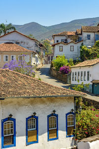 Houses and buildings in town against sky