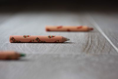 Close-up of crayons on wooden table