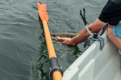 Low section of man on boat in sea