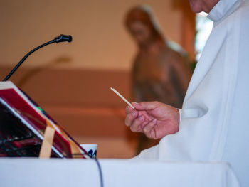 Midsection of priest standing in church