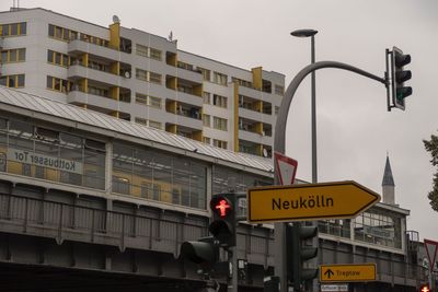 Road sign against buildings in city