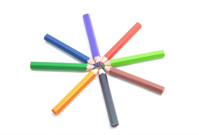 Close-up of colored pencils against white background