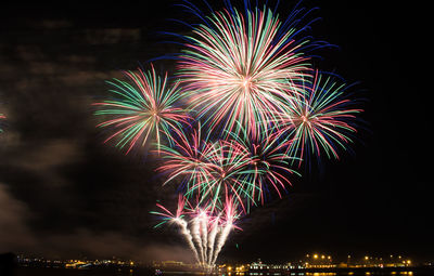 Low angle view of firework display at night