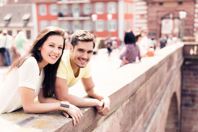 Portrait of smiling young woman sitting outdoors
