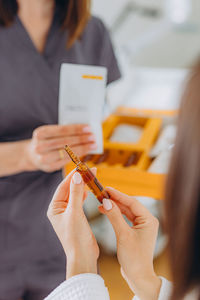 Midsection of woman using digital tablet