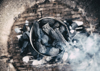 High angle close-up of coal on barbecue