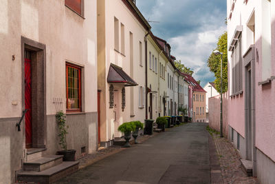 Quiet city lane with entrance doors of residential buildings facing the street. 