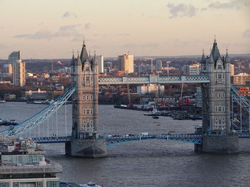 Bridge over river with buildings in background