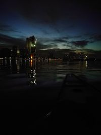Illuminated city against sky at night
