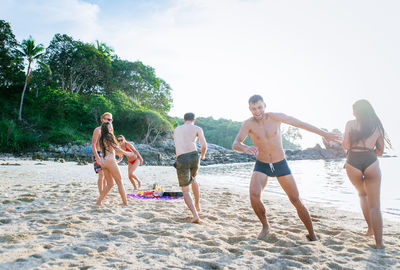 Friends enjoying at beach during summer