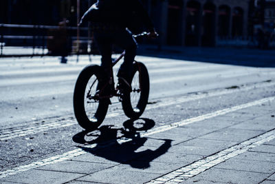 Low section of person riding bicycle