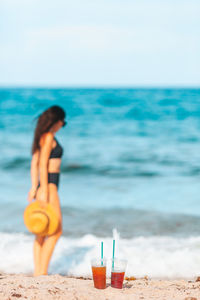 Portrait of young woman sitting on beach