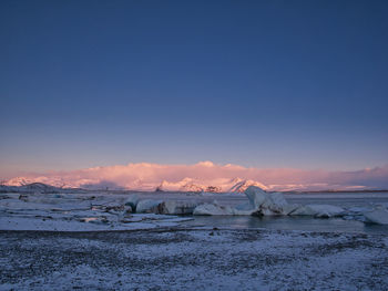 Scenic view of frozen lake against sky during winter