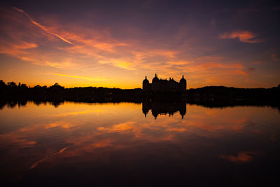 Scenic view of lake against orange sky