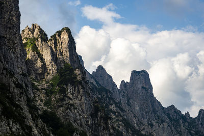 Low angle view of rocky mountains against sky