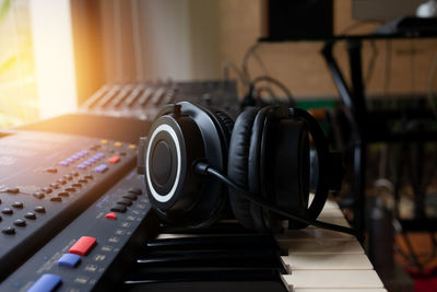 Close-up of headphones on piano