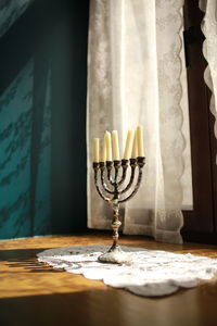 Close-up of drinking glass on table against window