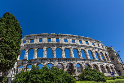 Low angle view of historical building against blue sky