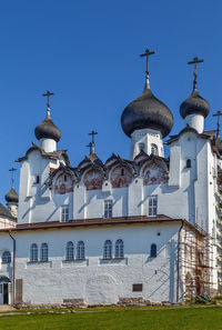 View of buildings against clear blue sky