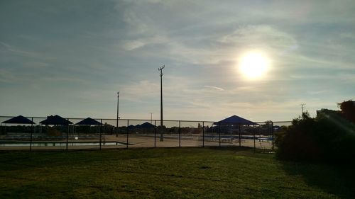 Houses on field against sky during sunset