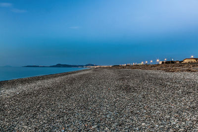 Scenic view of beach against blue sky