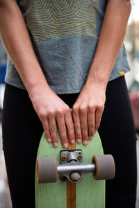 Female skater poses with her skateboard