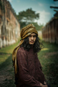Portrait of young woman standing outdoors