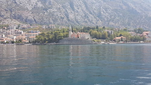 Scenic view of sea by buildings in city