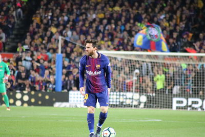 Group of people playing soccer on field