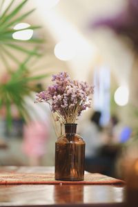 Close-up of purple flower vase on table