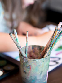 Close-up of paintbrushes in container on table