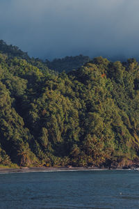 Scenic view of sea and mountains against sky