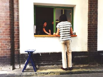 Full length of woman standing by railing