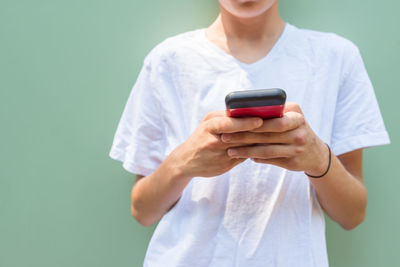 Midsection of man using mobile phone