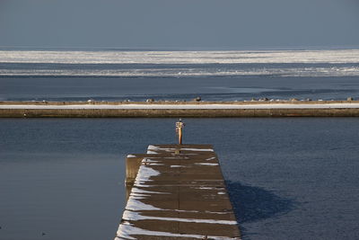 Pier on sea against sky