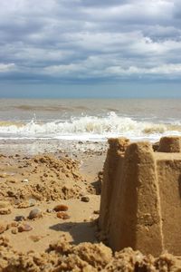 Scenic view of sea against cloudy sky